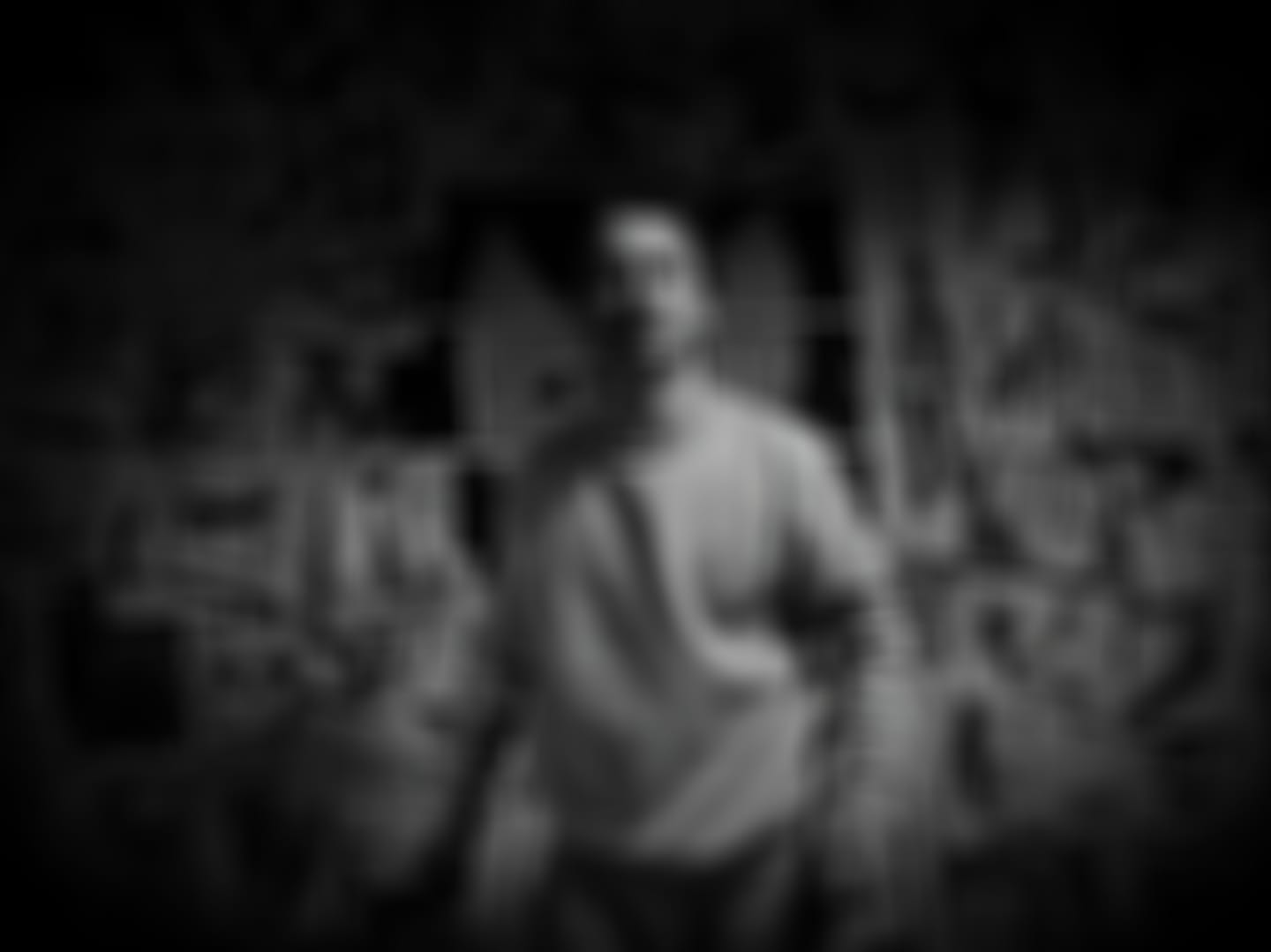 Deliberately blurred black-and-white frame from We Came By